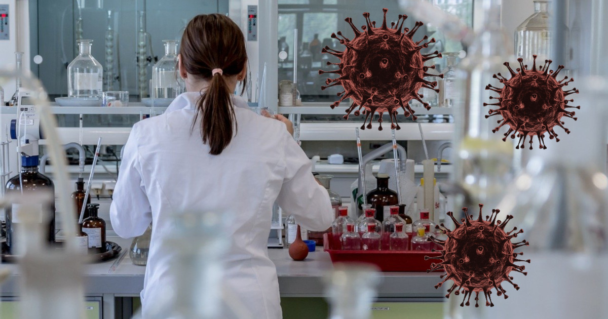 scientist in a laboratory with their back turned while renderings of the coronavirus float through the air