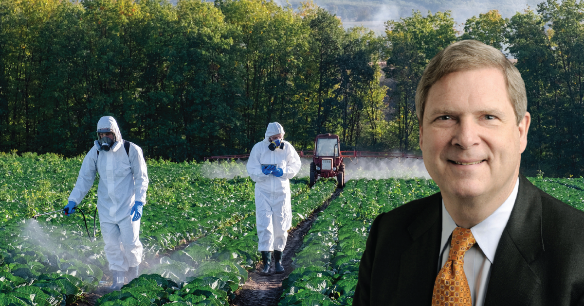 Tom Vilsack in front of a field being sprayed with pesticides.