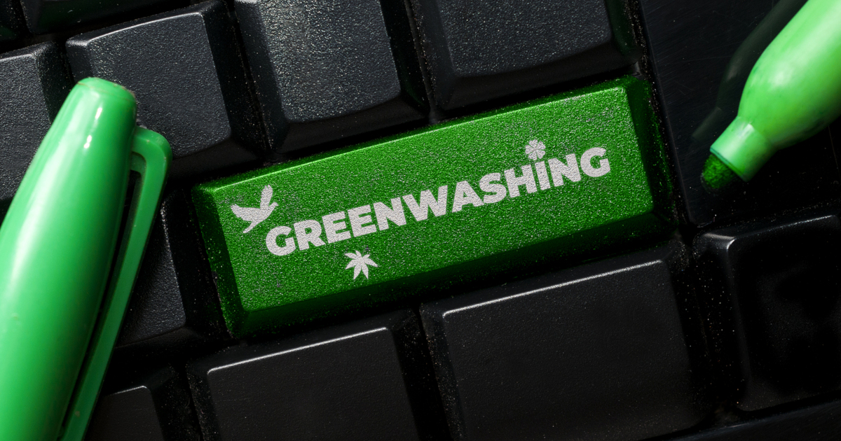 green button on a black keyboard that says GREENWASHING surrounded by green markers