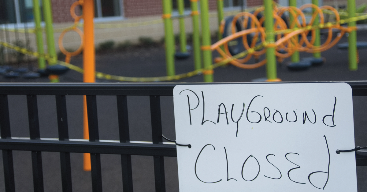 A playground that has a closed sign.