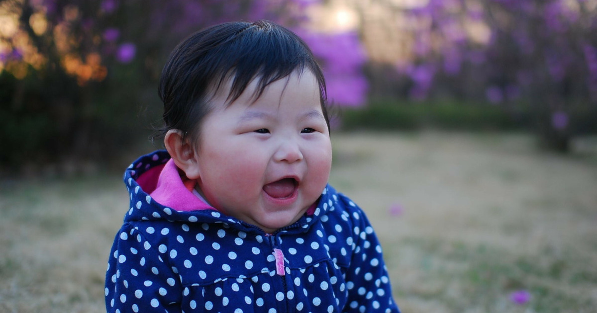 baby girl outside smiling