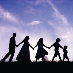 silhouette of a family walking in a line holding hands
