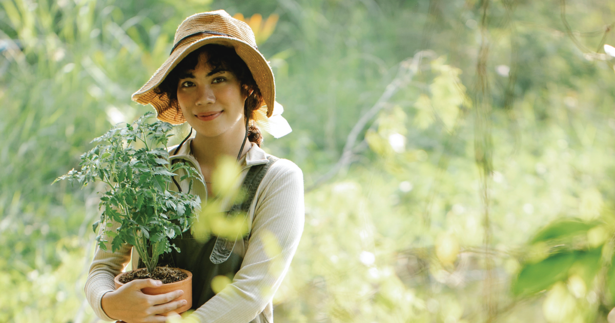 A woman holding a potted plant.