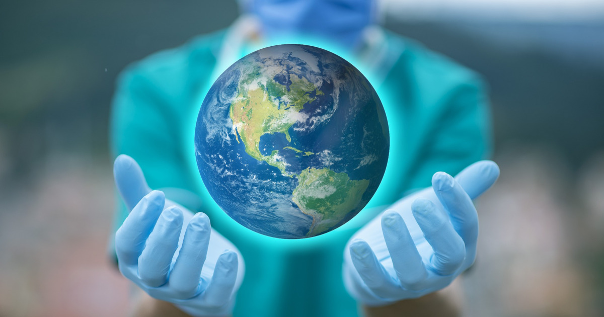 person wearing medical gloves holds globe