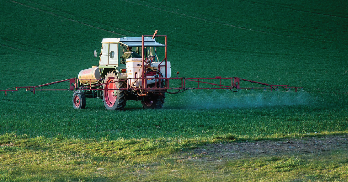 A tractor spraying pesticides.